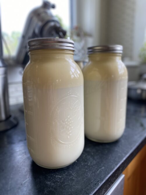 Milk with cream on top on the kitchen counter